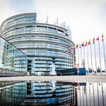 Building of the European parliament in Strasbourg - Reflection of Louise Weiss building in water puddle - Fall season